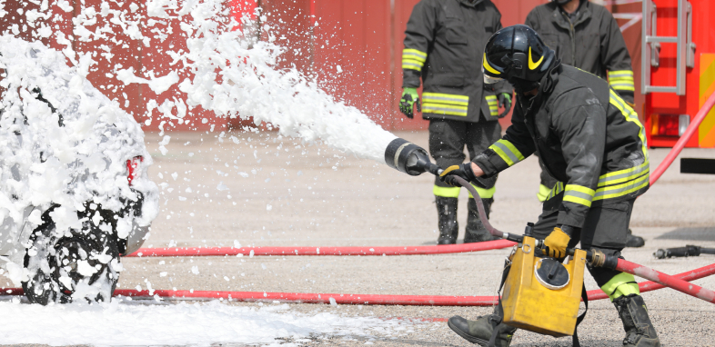 Firefighter with foam spray, symbolizing fire suppressant foam lawsuits.