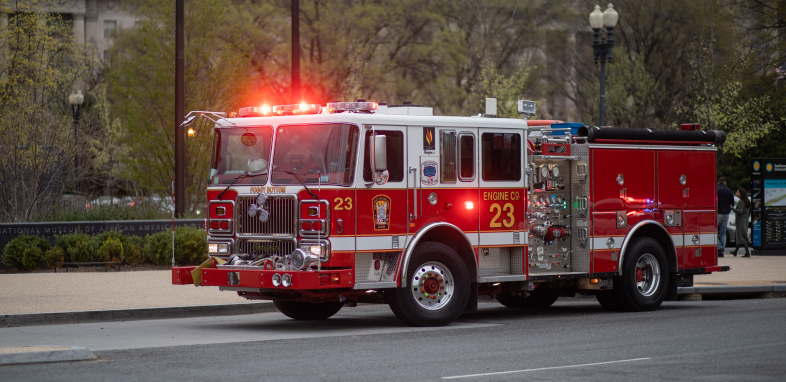 A fire truck with the lights on, illustrating defective product fire cases.