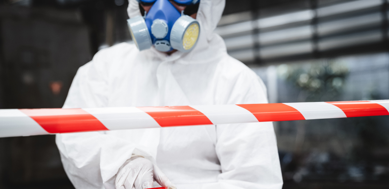 A person wearing a protective hazmat suit, representing environmental injury cases.