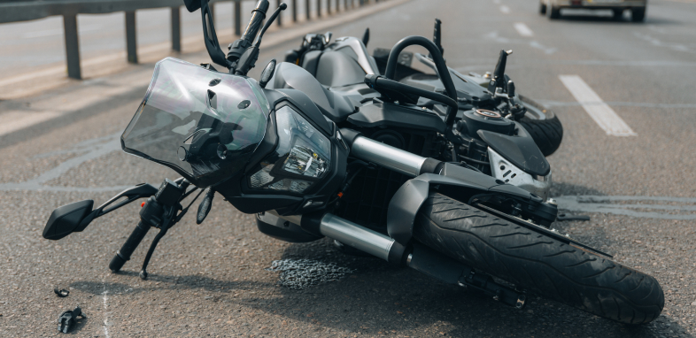 Motorcycle tipped over after an accident, symbolizing motorcycle accident cases.