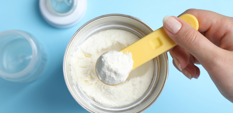 A scoop of baby formula representing baby formula lawsuits.