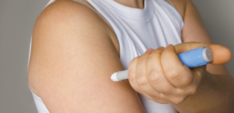 A syringe being injected into the arm, symbolizing Ozempic-related claims.