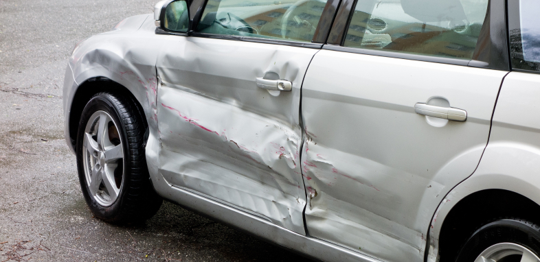 A car with side damage from a collision, representing sideswipe accident claims.