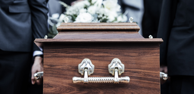 The end of a coffin, illustrating wrongful death lawsuits.